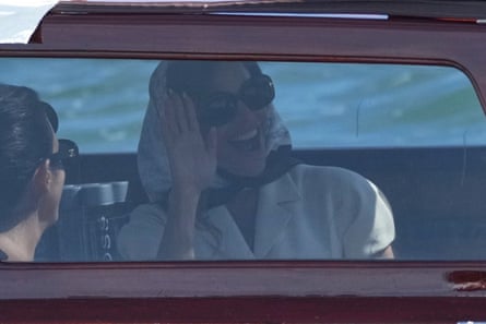 Sanchez waves from a boat on her way to San Giorgio Maggiore.