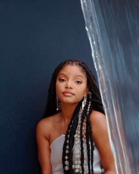 Dress by Kate Barton; headpiece by Gucci; earrings by Leigh Miller. Styling: Anna Su. Hair: Tinisha Meeks. Makeup: Christiana Cassell.