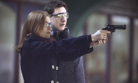 Isabelle Huppert on the gun range in Elle