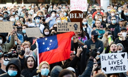 A protester carrying the Samoan flag marches in a Black Lives Matter Rally in Sydney on Saturday.