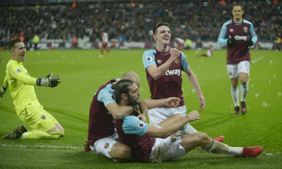 West Ham players celebrate Andy Carroll’s dramatic late winner at the London Stadium.