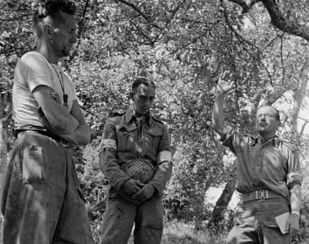 British army chaplain the Rev Leslie Skinner (right) conducts a funeral for a serviceman in a British forward area of Normandy during the second world war, 14 August 1944