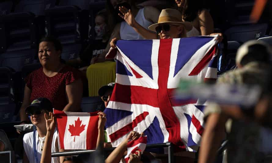 Fans hold up flags during the final.