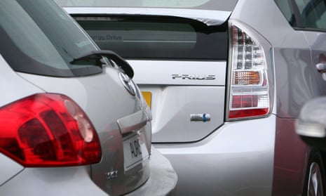 A Toyota Prius hybrid car and a Toyota Auris at a Toyota dealership