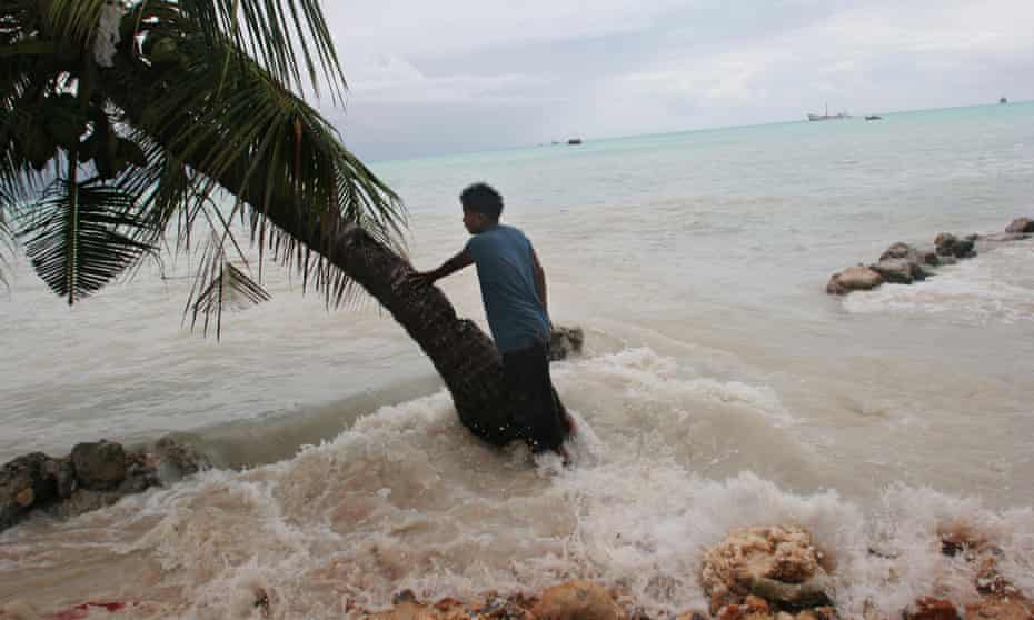 King tides crash through the sea wall, flooding Pita Meanke’s family property on the low-lying South Pacific island of Kiribati.