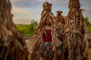 Young women covered in banana leaves and mud celebrating the Feast of Saint John the Baptist in Aliaga. Known as the “Taong Putik’ (mud people), the ritual happens yearly in this small farming village