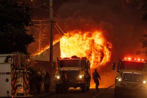 Firefighters attempt to stop the spread of flames as they consume a home.
