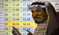 A Saudi trader in front of a screen displaying the Saudi stock market at the Arab National Bank in Riyadh.
