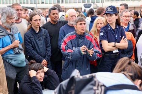 Activists of the Global Sumud Flotilla speak among a crowd of people.