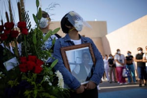 Elizabeth Tovar holds a photograph of her mother Clara Tovar, during a tribute to the former nurse who died of coronavirus in Ciudad Juarez, Mexico.