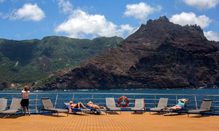 Tourists lie on the deck of a cruise ship in French Polynesia
