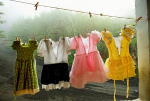Girls’ dresses hang on a laundry line in a porch in Puerto Rico