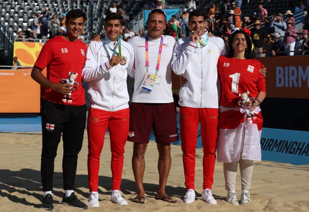 Javier Bello and Joaquin Bello celebrate bronze in the beach volleyball with family members