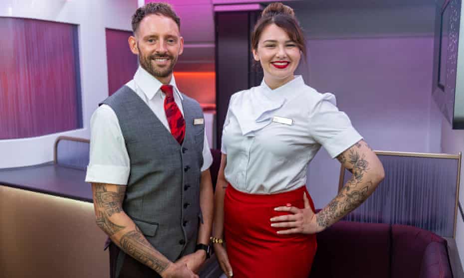 Virgin flight crew show the tattoos on their arms