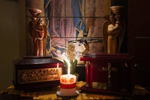 A family altar in the Martínez family home. On the left, the remains of Mercedes Chichil rest in an urn next to the urn chosen for Juan Martínez.