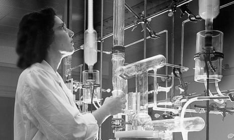 Woman scientist examines her scientific apparatus
