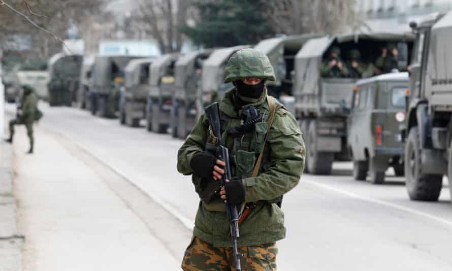 Armed servicemen wait in Russian army vehicles outside a Ukranian border guard post in the Crimean town of Balaclava, 1 March 2014.