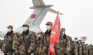 Chinese military medical staff arrive in Wuhan as the coronavirus death toll passes the Sars epidemic fatalities.