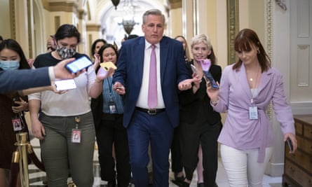 The House minority leader, Kevin McCarthy, heads to his office surrounded by reporters.