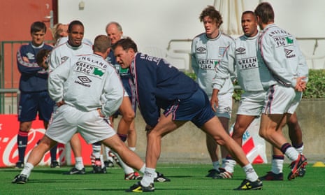 Glenn Hoddle limbers up beside his England squad during training for their opening match at the 1998 World Cup in France