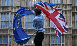 UK and EU flag being waved in front of UK parliament