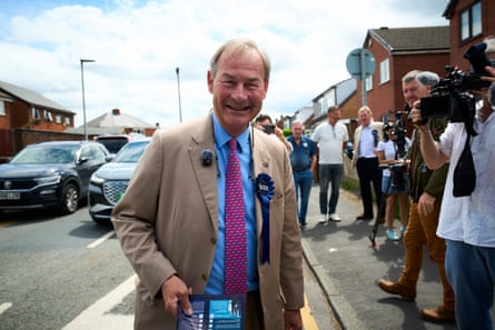 Rupert Lowe handing out flyers for Restore Britain on a suburban street