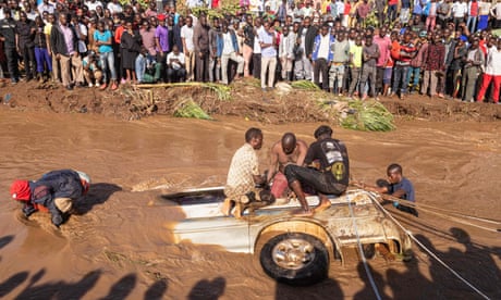 Villagers try to retrieve bodies from a minibus partly submerged in the Nabuyonga River in Namakwekwe, eastern Uganda