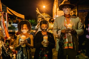 Just as people in cities across America came out onto the streets to protest the police killing of George Floyd in Minneapolis in May, so Minneapolis resident take to rallies for incidents elsewhere, too. Here, a family stands at a candlelit vigil in Minneapolis last night in honor of Jacob Blake, who is still fighting for his health in a hospital in Kenosha, Wisconsin, after being shot in the back by a police officer last Sunday.