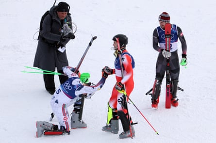 Henrik Kristoffersen bows down to Loïc Meillard as Fabio Gstrein watches on.