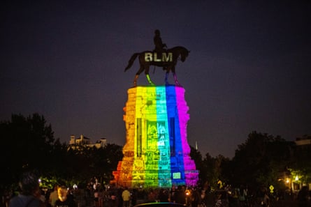 The Pride rainbow colors are projected over a statue of Confederate general Robert E Lee, adorned with BLM for Black Lives Matter, that still stands in Richmond.