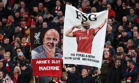Liverpool fans show off banners paying tribute to Mo Salah and Arne Slot at Anfield.