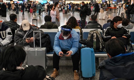 Passengers wait for their train at Hongqiao railway station in Shanghai