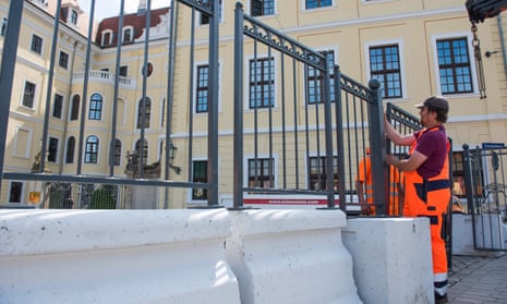 Workers erect a barricade outside the Taschenbergpalais hotel in Dresden