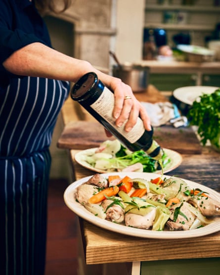 A female pouring lipid onto a chickenhearted dish