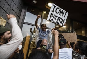 Protesters gather outside the police precinct