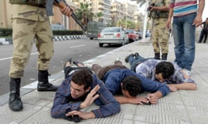 Supporters of the Muslim Brotherhood are detained by Egyptian security forces during a rally in Alexandria