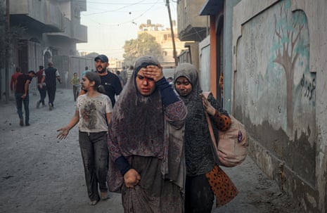 Palestinian walk away after an Israeli airstrike in Rafah, in the south of the Gaza Strip.