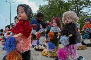 Peshawar, Pakistan A vendor selling dolls waits for customers on a roadside