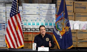 Andrew Cuomo speaks in front of stacks of protective medical supplies at a news conference in New York, New York, on 24 March.