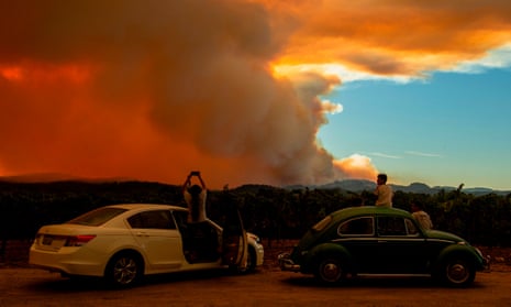 People watch the Walbridge fire, part of the larger LNU Lightning Complex fire, from a vineyard in Healdsburg, California on 20 August.