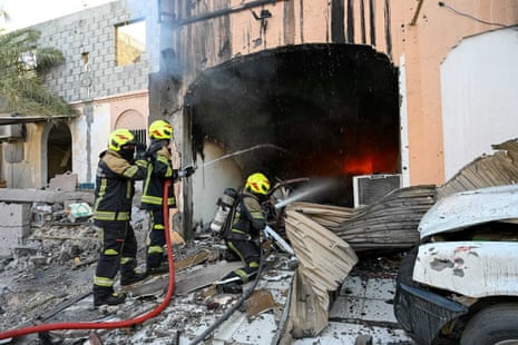 Firefighters work to put out a fire in a building.
