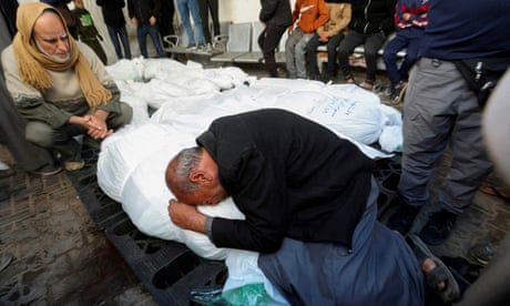 Man mourns next to bodies