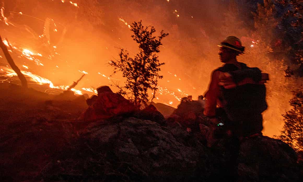 A firefighter amid intense flames