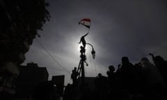 An Egyptian protestor climbs a pole waving his national flag during a demonstration in Tahrir Square, Cairo, Egypt. (AP Photo/Nathalie Bardou)