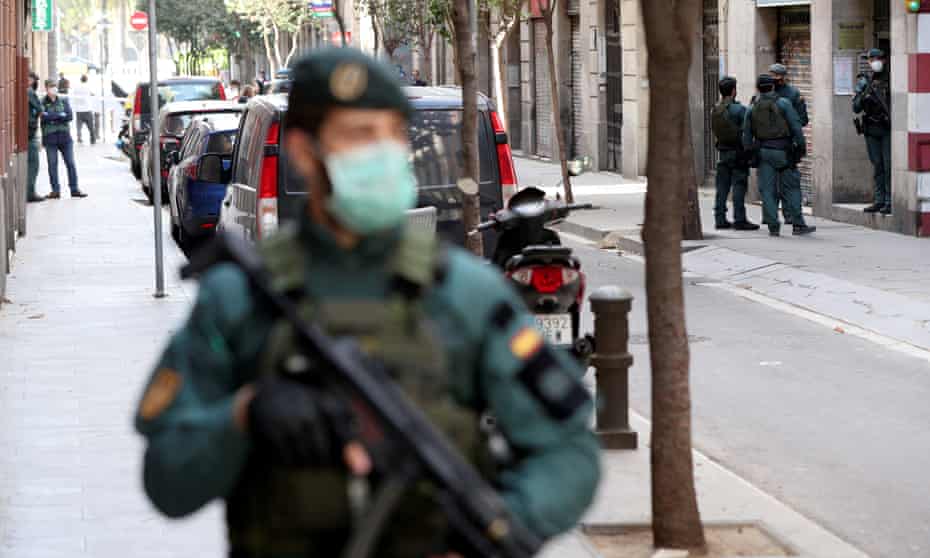 A police officer stands guard at the scene of the arrest in Barcelona
