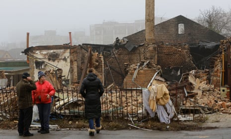 People gather near a building destroyed in recent shelling in Donetsk, Ukraine, earlier today.