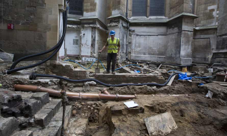 Archaeologist Paw Jorgensen stands above a collection of bones that were found among the stepped footings of Westminster Abbey’s south transept.