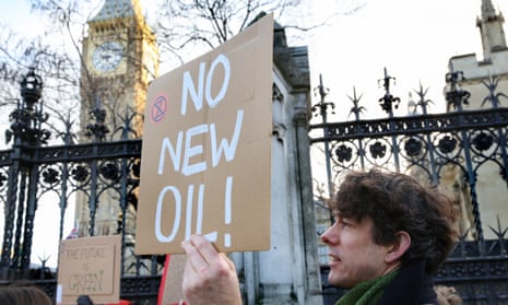 Environmental protesters gather outside the Houses of Parliament to protest against the Offshore Licensing Bill. A protester holds a placard reading “No New Oil” during the demonstration.