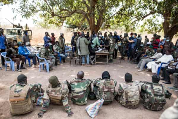 Seven captured Senegalese soldiers sit in a line as MFDC separatists declare their release at an abandoned settlement, Baipal, in the Gambia in February.