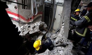 Rescue workers at the scene after a fire caused deaths and injuries at the main train station in Cairo, Egypt